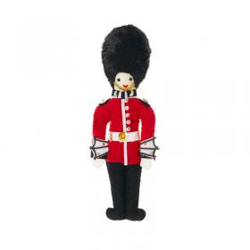 "Felt Guardsman decoration with magnet backing to attach to a fridge and gold trim details. Inspired by a British icon, a Royal Guardsman resplendent in red tunic and tall black bearskin hat.  This product was designed in London and handmade in Thailand b